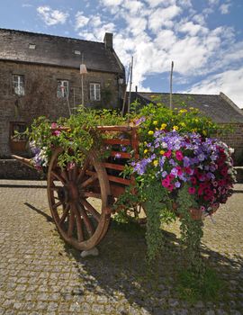 Floral display in an old wooden cart, in the village of Locronan, in Brittany, rural France