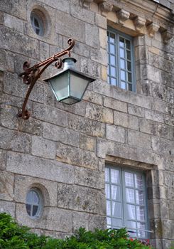 Old lamp in Locronan, Brittany, France.