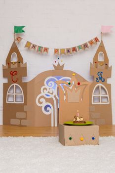 cardboard childrens palace with a throne and a cake