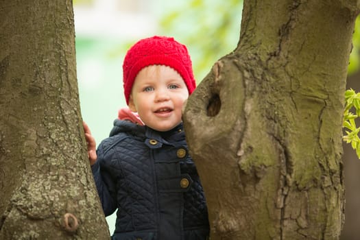 cute little girl playing in the park in spring