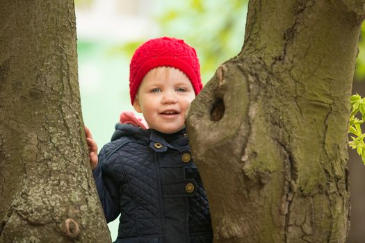 cute little girl playing in the park in spring