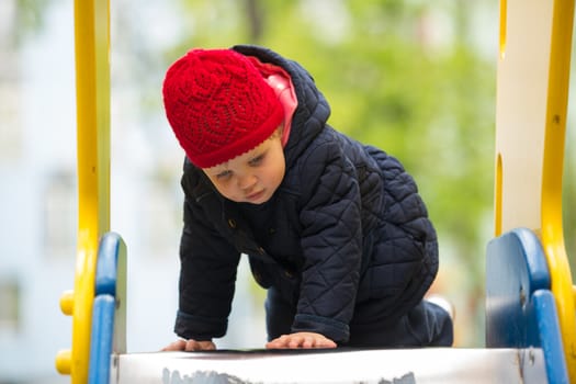 girl playing in a spring park in a playground