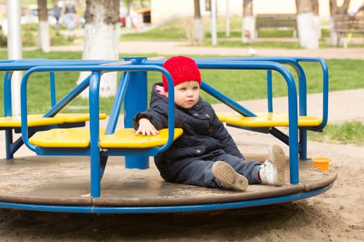 girl playing in a spring park in a playground