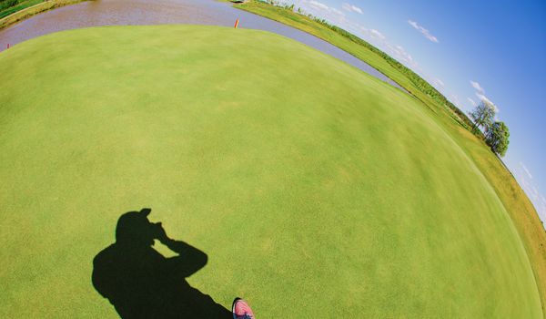 Photographer shadow with grass background at summer day