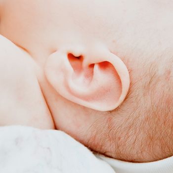 Small delicate little ear of newborn. Close up