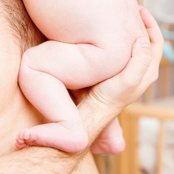 Closeup of baby hand into parents hands. Family concept