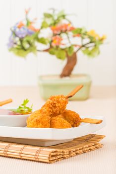 Skewers of coconut crusted chicken photographed closeup.