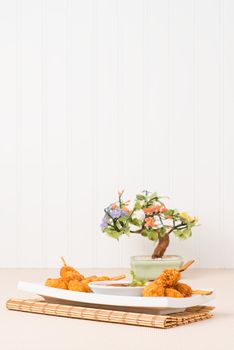 Skewers of coconut chicken with a sweet and spicy dipping sauce.