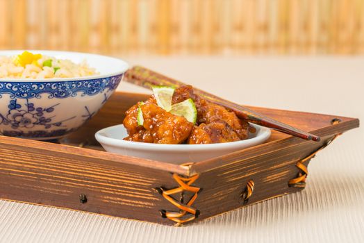 Closeup view of General Tao Chicken and vegetable fried rice.