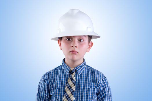 Aspiring young tween boy dreaming of becoming an engineer in hardhat and necktie with a whimsical expression - I am going to be an engineer - against a blue background