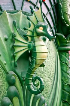 A green Seahorse statue in park