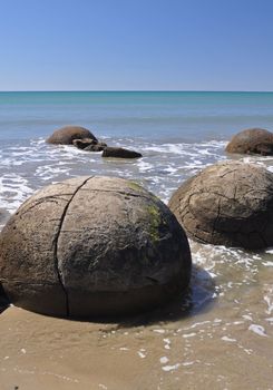 Moeraki Boulders are perfectly sperical rocks on the beach at Moeraki, north of Dunedin, near Oamaru. Up to 13 feet round Maori believe they were food baskets on the original Maori canoe