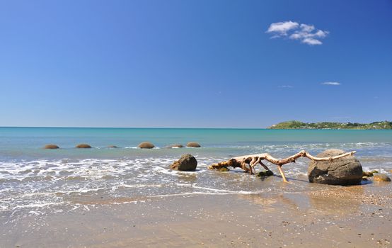 Moeraki Boulders are perfectly spherical rocks on the beach at Moeraki, near Oamaru. Up to 13 feet round Maori believe they were canoe food baskets.