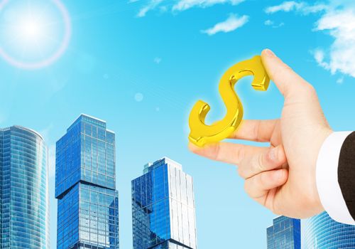 Businessman hand with dollar sign on city background