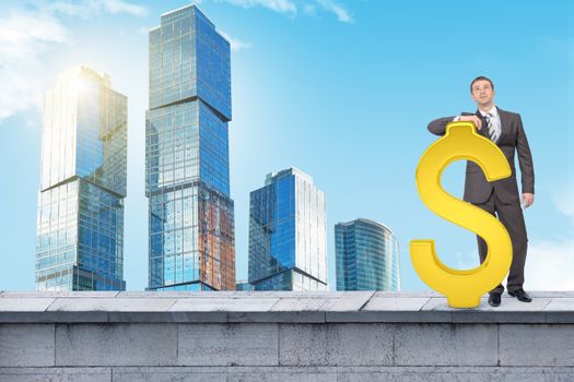 Businessman standing with big dollar sign on building roof