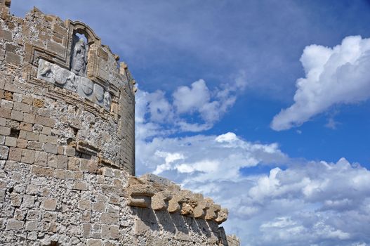 St. Nicholas fortress guards the mouth of Mandraki Harbour on the greek island of Rhodes. The fort, now a lighthouse, stands at the site of the legendary Colossus of Rhodes.