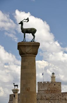 St. Nicholas fortress, now a lighthouse, guards the mouth of Mandraki Harbour on Rhodes. Twin statues of Rhodian deer stand on top of columns either side of the harbour entrance, once the site of the legendary Colossus of Rhodes.