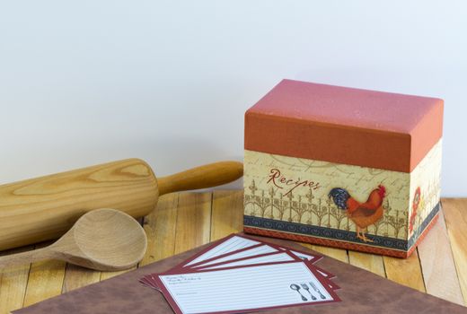 Kitchen scene with recipe box, blank recipe cards, and wooden rolling pin and spoon