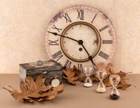 "Time" theme with wall clock, hourglasses, wristwatch, and pocket watch with autumn leaves