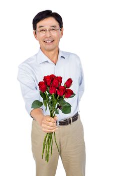 Older asian man offering roses on white background