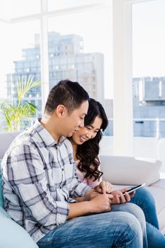 Young couple using smart phone at home 