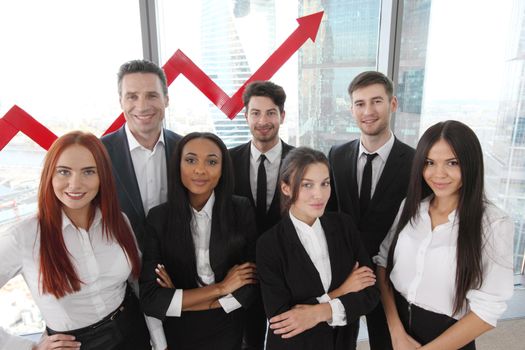 Portrait of business team of men and women in office with arrow graph of income growth