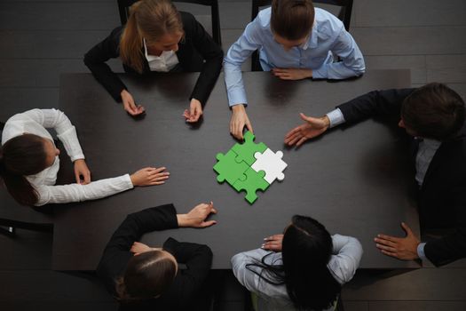 Group of business people assembling jigsaw puzzle, team support and help concept