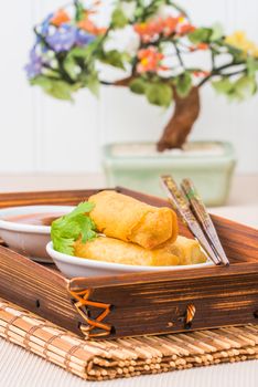 Spring rolls and dipping sauce photographed closeup.