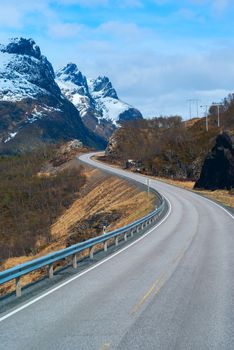 Grey road in Norvegian snowbound mountains