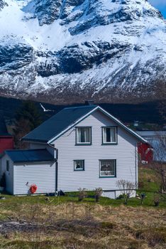 Lonely house under the mountain on Lofoten in Norway