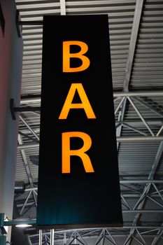 Red neon light as advertisement for a Bar