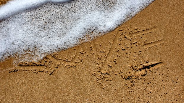 love message written in sand at beach