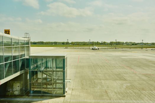 Airplane at the terminal gate ready for takeoff - Modern international airport during sunset - Concept of emotional travel around the world