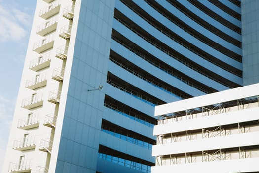 Perspective and underside angle view to textured background of modern glass building 