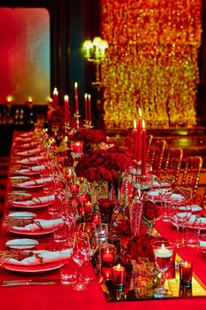 Table set for wedding or another catered event dinner in red colors