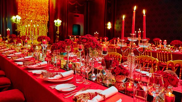 Table set for wedding or another catered event dinner in red colors