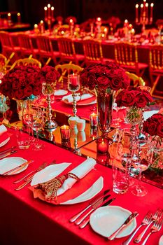 Table set for wedding or another catered event dinner in red colors