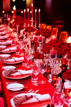 Table set for wedding or another catered event dinner in red colors