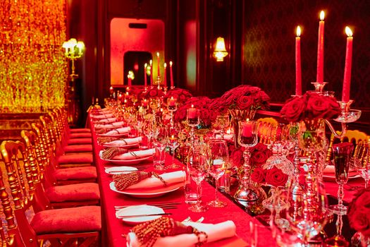 Table set for wedding or another catered event dinner in red colors