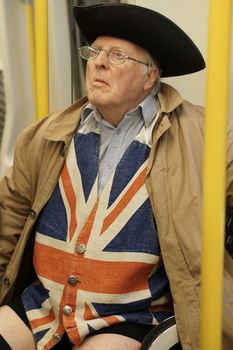 UK, London: A Londoner follows in the annual tradition of New York City's No Pants Subway Ride by joining London's No Trousers Tube Ride on January 10, 2016. Participants met in London's Chinatown and traveled from Leicester Square to Monument station as they braved the chilly weather.