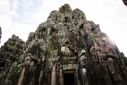 Angkor Wat Cambodia. Khmer ancient Buddhist temple under the picturesque sky with clouds and sunlight. Famous landmark, place of worship in Asia.