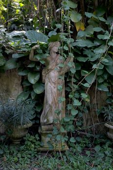 Sculpture covered with moss in garden