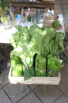 Organic green vegetable wrapped with banana leaf