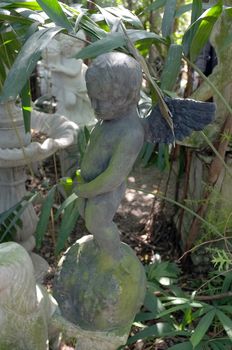 Sculpture covered with moss in garden