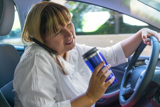 portrait of a woman driving a car with his hands busy