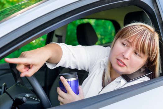 woman 50 years with busy hands driving shows forward