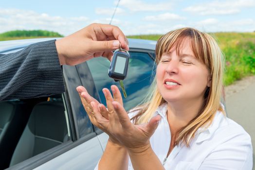 buying a new car, a happy woman gets key