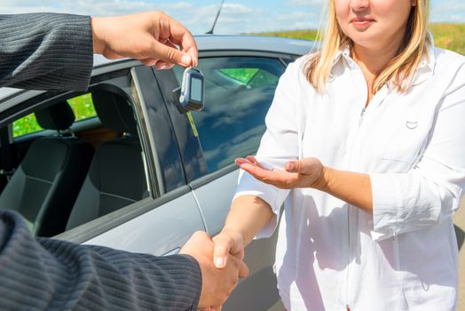 Handshake and handing over keys of new car