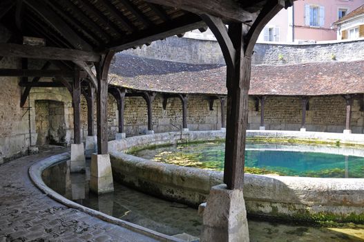 Tonnerre in the Morvan, Burgundy, France sits on the River Armancon. Famed for theTonnerre Fosse Dionne wash house