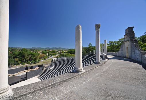 The extensive Roman ruins at Vaison-La-Romaine, Provence, France. These Gallo-Roman remains are situated in the very centre of the fascinating ancient town of Vaison-La-Romaine. The ruins shown are within the Quartier De Puymin ( Puymin Hill ). The Roman Theatre shown seated 6000 people and was built in the 1st Century. Part of the top gallery Portico remains and is shown.